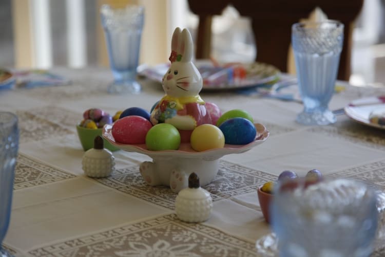 Table in sunroom set in soft pastels.