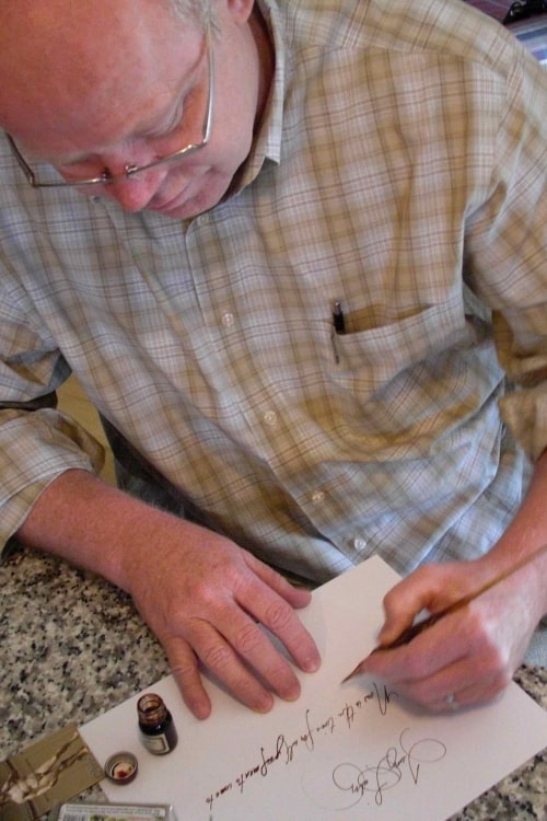 Terry writes with his new pen.